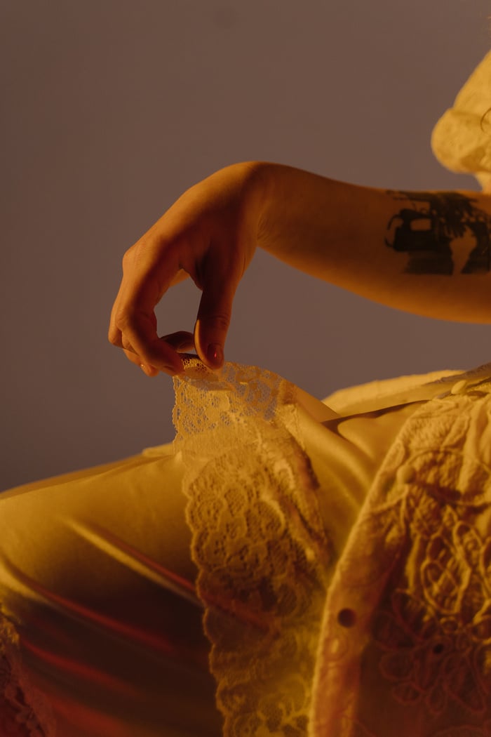 Close-up Photo of Woman in Beige Lace Dress