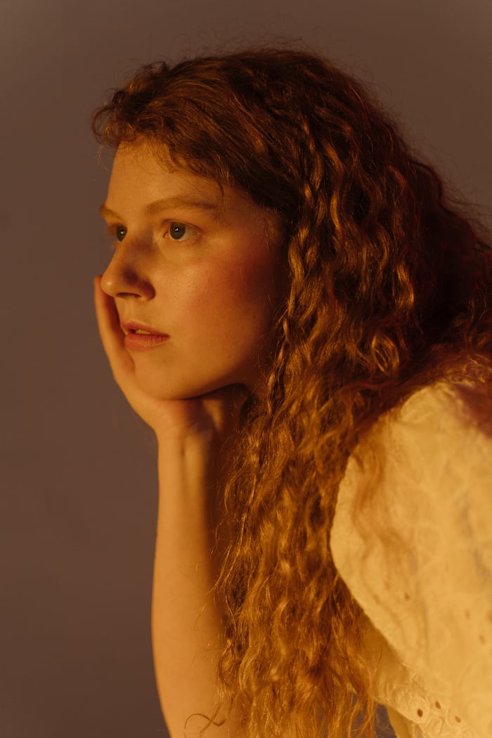 A Woman with Curly Hair Looking Afar